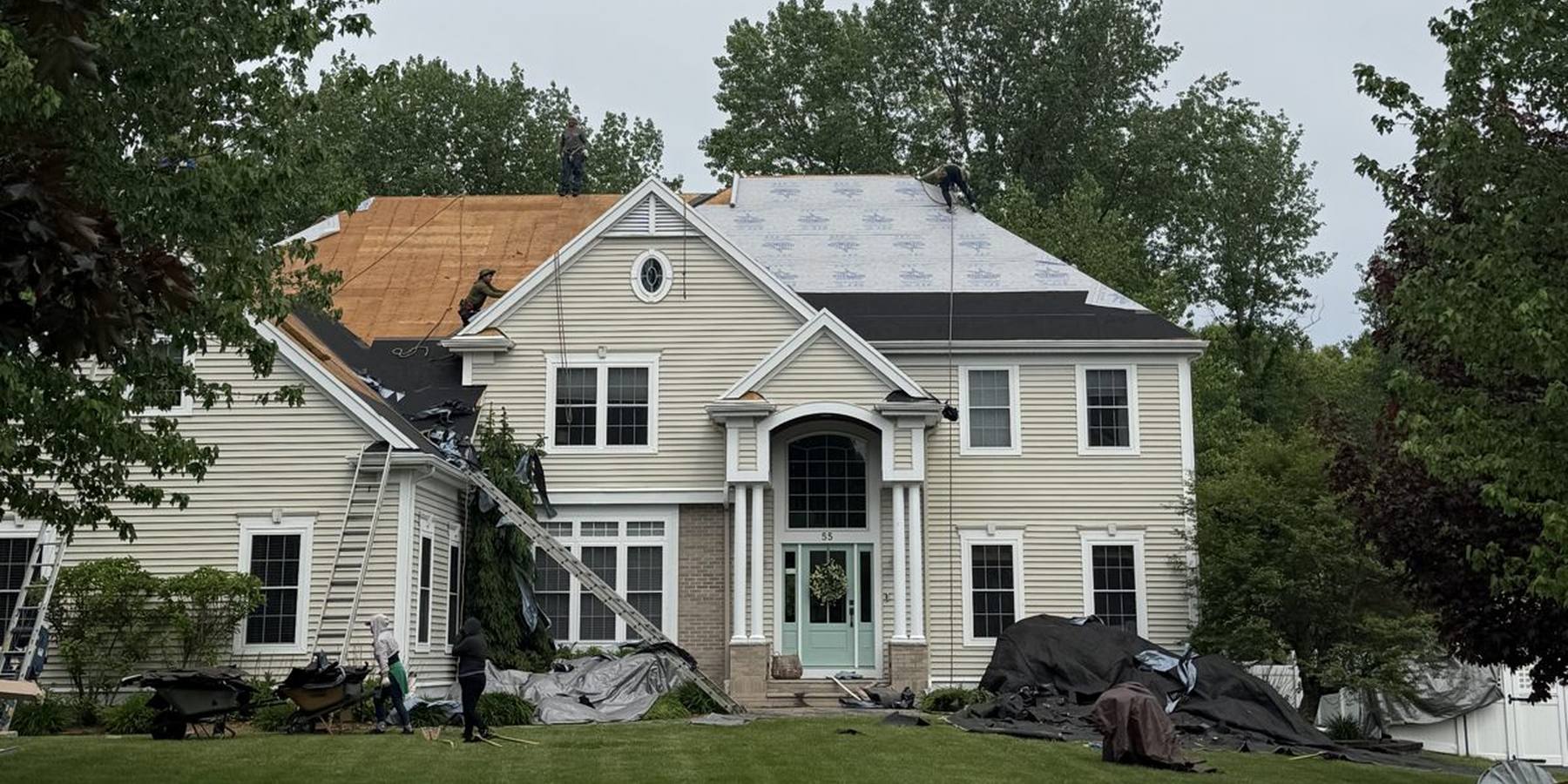 The Rocco's Roofing crew replacing the roof on a New England colonial home
