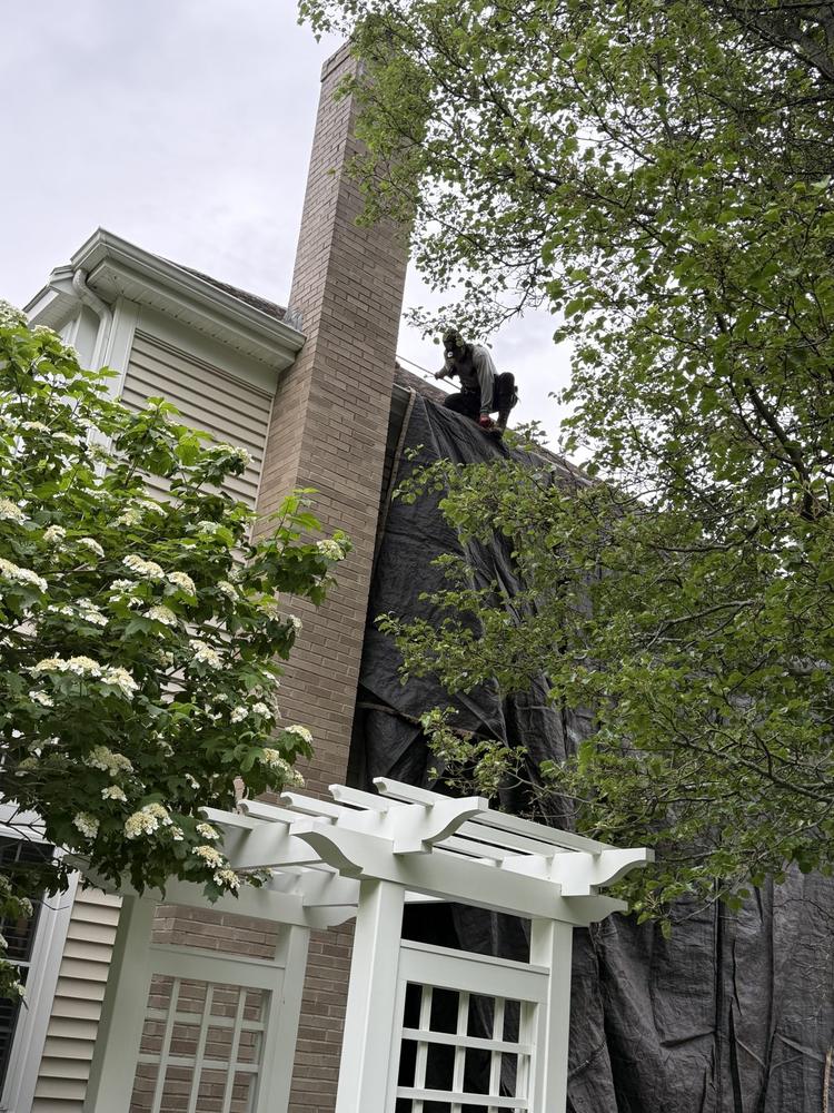 Full roof replacement around a brick chimney