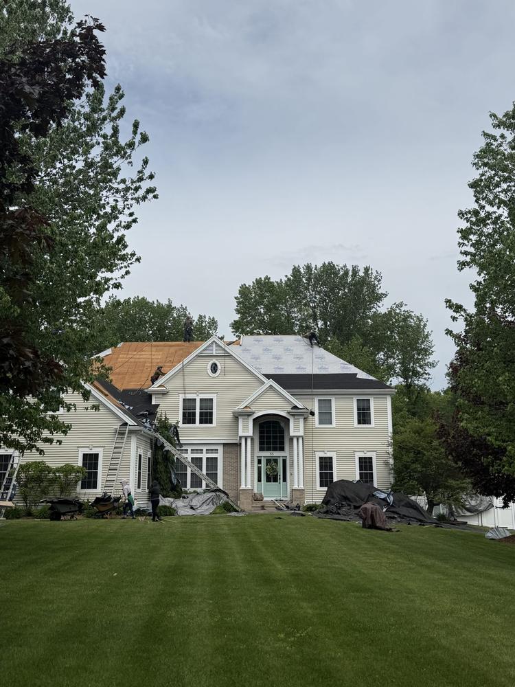 New roof installation on a large colonial home
